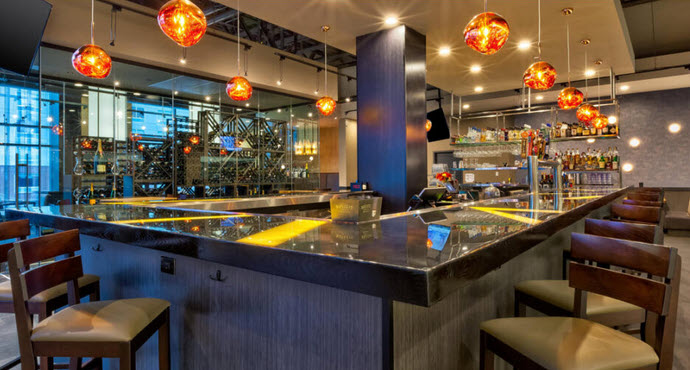 A view of the bar area of Crave Restaurant and Drinks which is inside Hotel Indigo Rochester, MN - Mayo Clinic Area